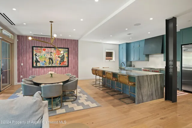 a large kitchen with a table and chairs