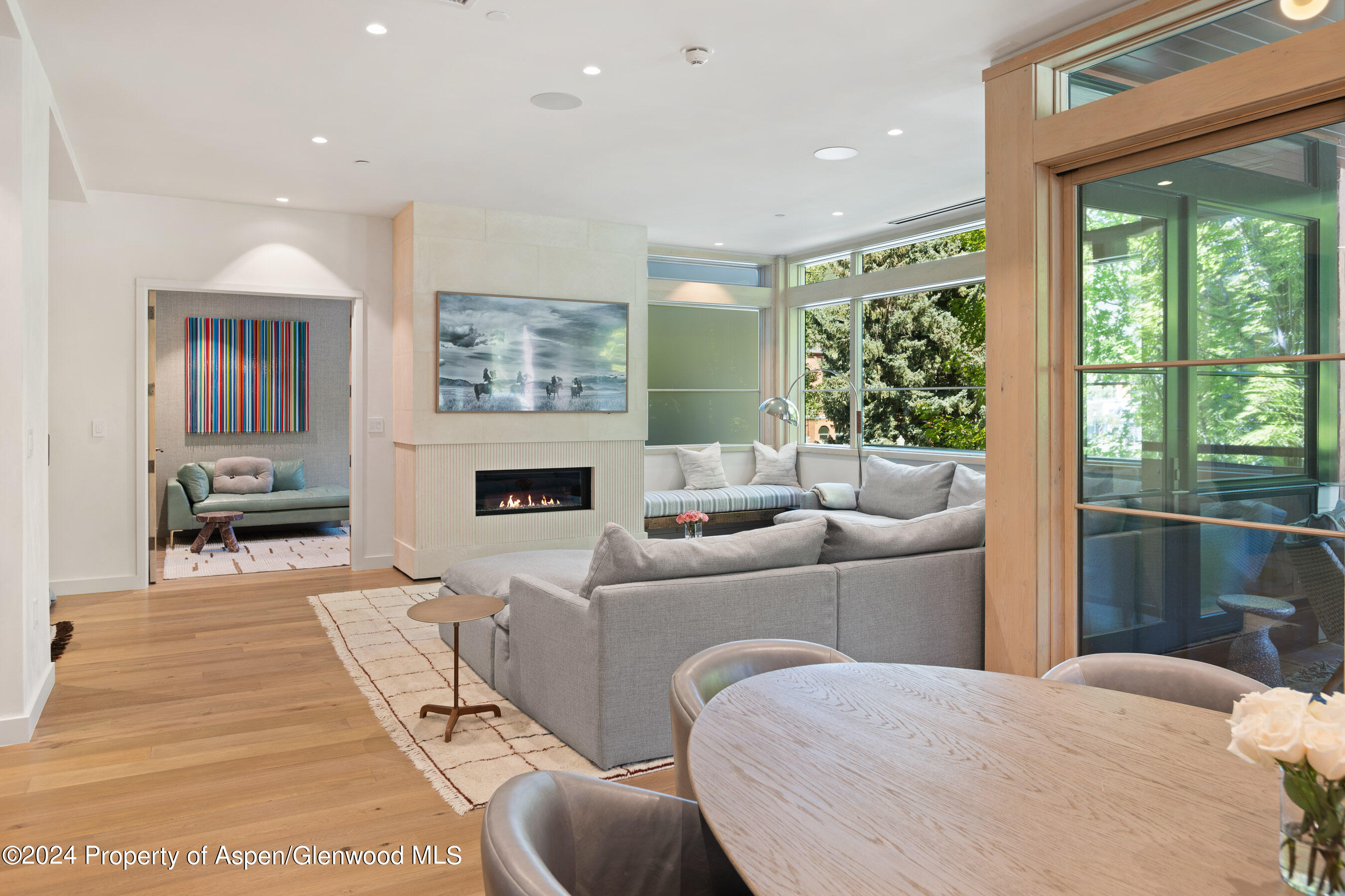 405 South Monarch Street, Unit 209 Aspen, CO 81611 - Photo 10 of 33 a living room with furniture a fireplace and a large window