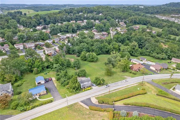 an aerial view of a house with a swimming pool