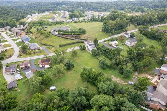 an aerial view of lake residential house with outdoor space and trees around