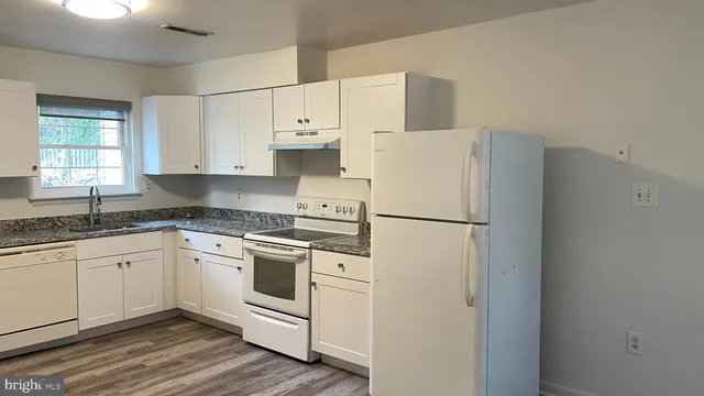 a white refrigerator freezer sitting inside of a kitchen