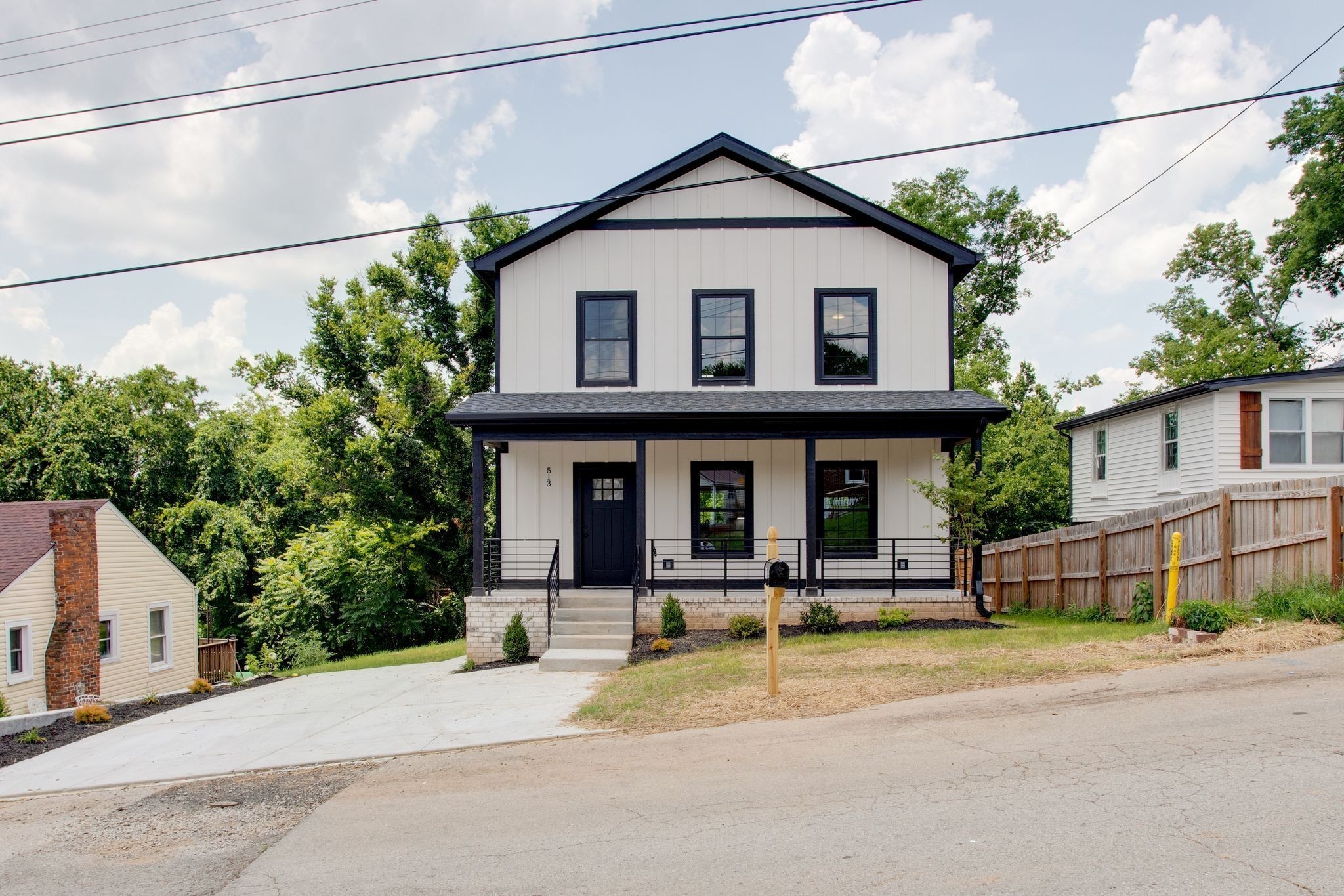 513 Transit Avenue Columbia, TN 38401 - Photo 1 of 26 a view of a white house with large windows and a small yard