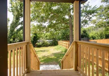 a view of balcony with wooden floor and fence