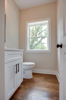 a bathroom with a toilet sink and window