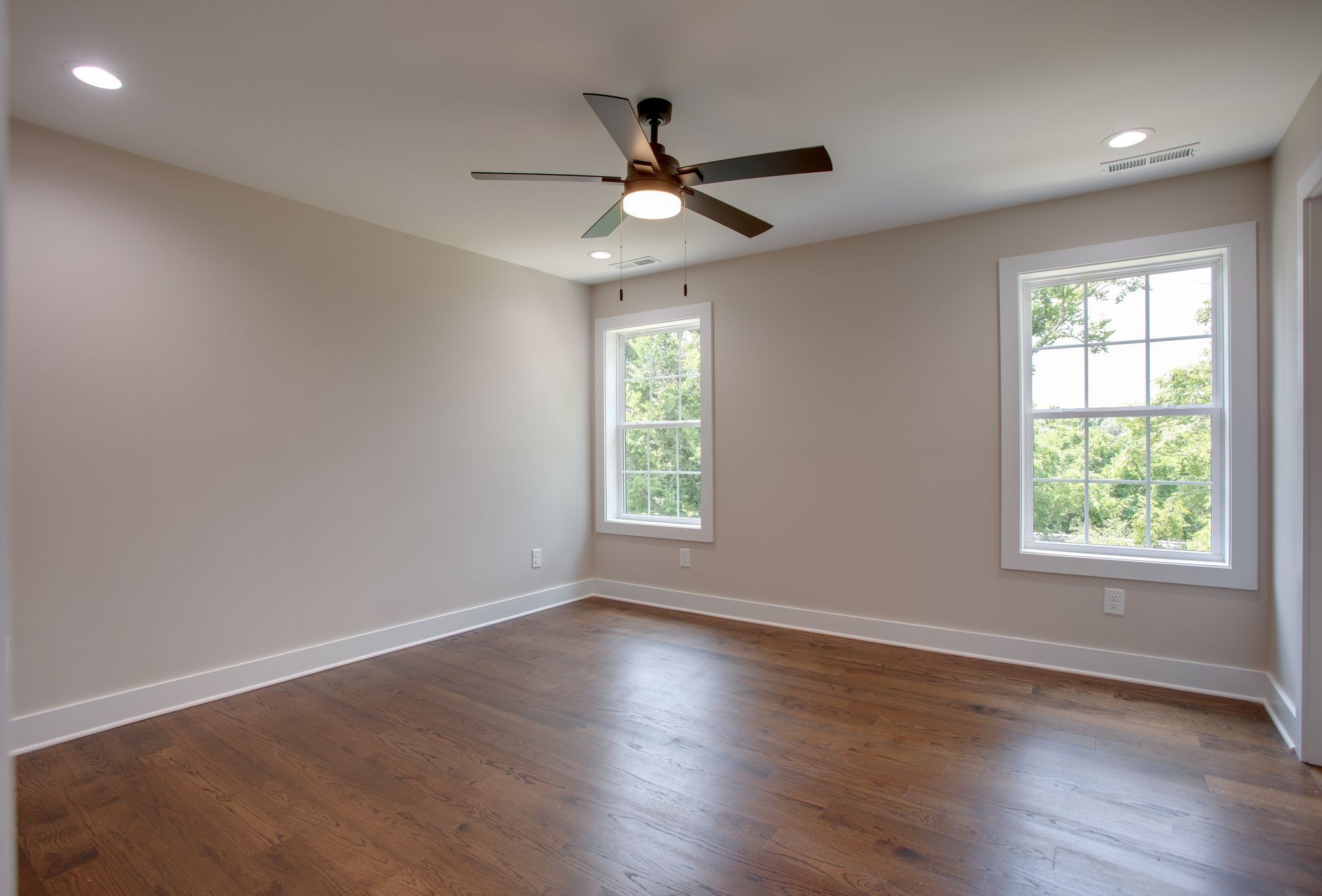 513 Transit Avenue Columbia, TN 38401 - Photo 10 of 26 an empty room with wooden floor ceiling fan and windows
