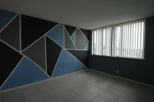 a view of an empty room with windows
