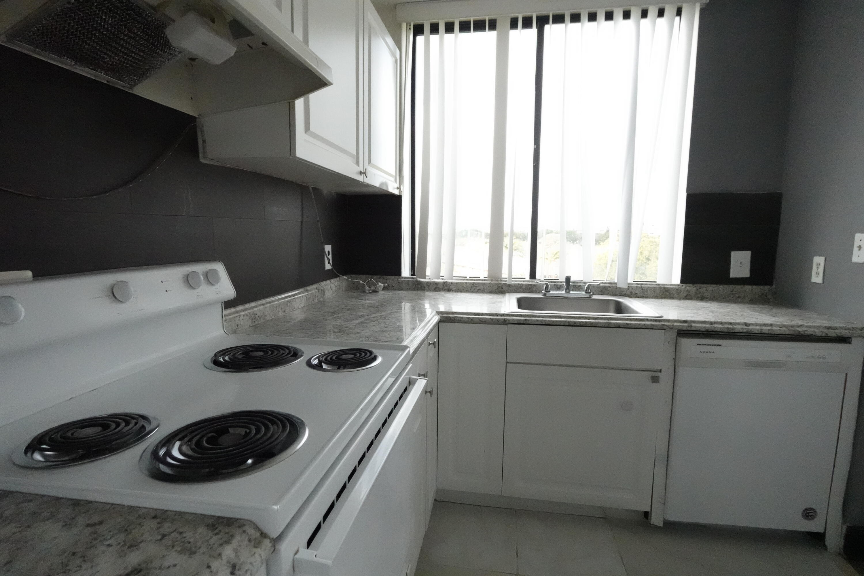 4200 Inverrary Boulevard, Unit 3516 Lauderhill, FL 33319 - Photo 6 of 19 a kitchen with a stove and a sink