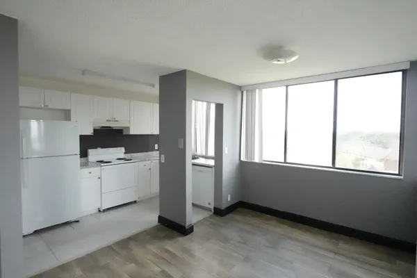 a kitchen with window and white cabinets