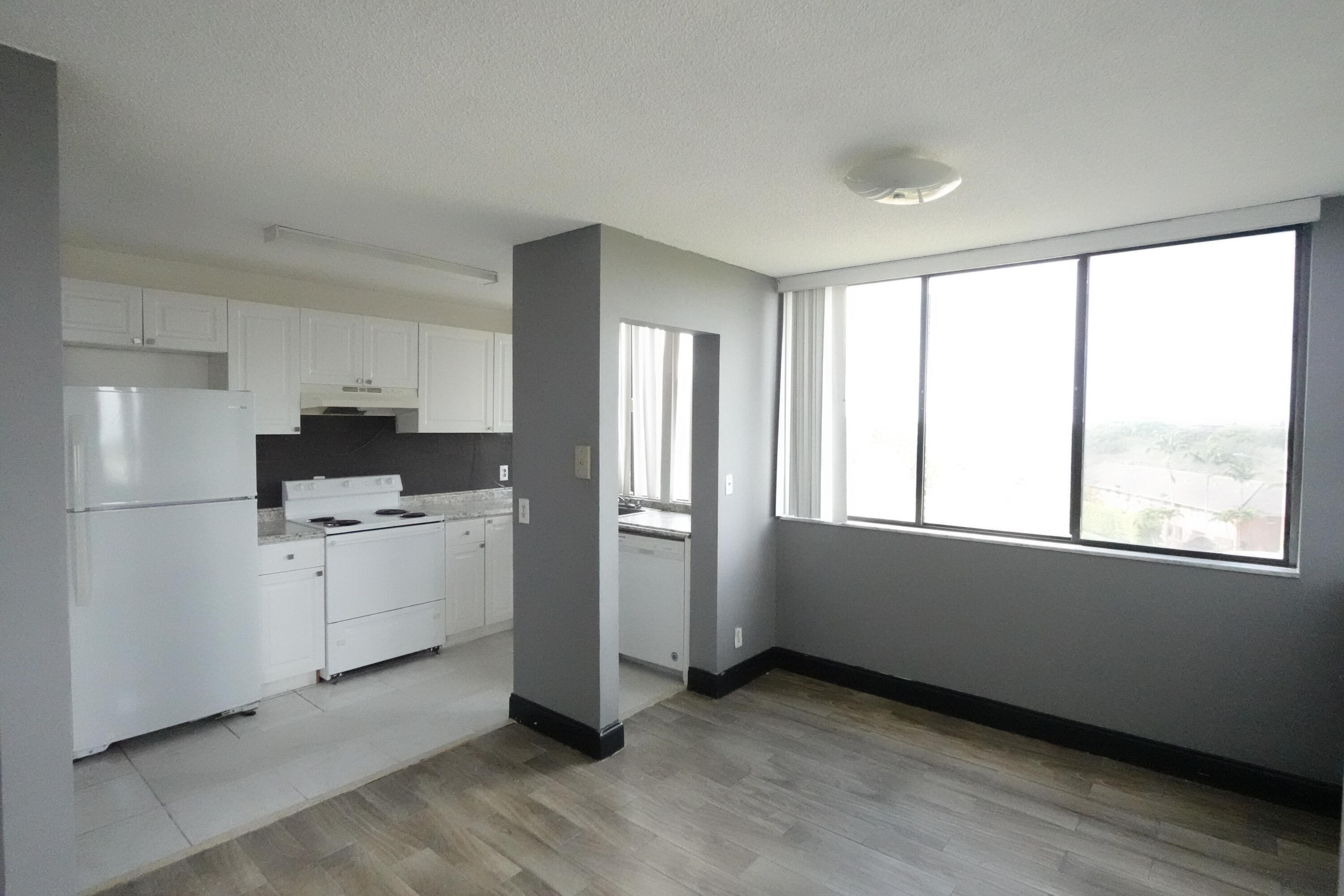 4200 Inverrary Boulevard, Unit 3516 Lauderhill, FL 33319 - Photo 8 of 19 a kitchen with window and white cabinets