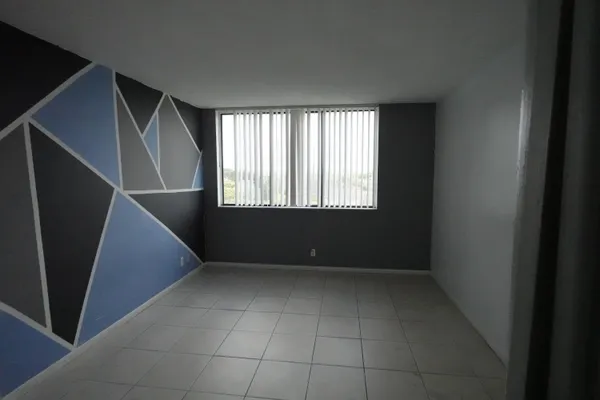 a view of an empty room with a window