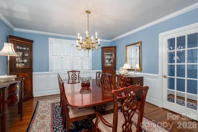 a view of a dining room with furniture and chandelier