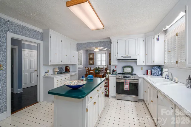 a kitchen with a sink stove and cabinets