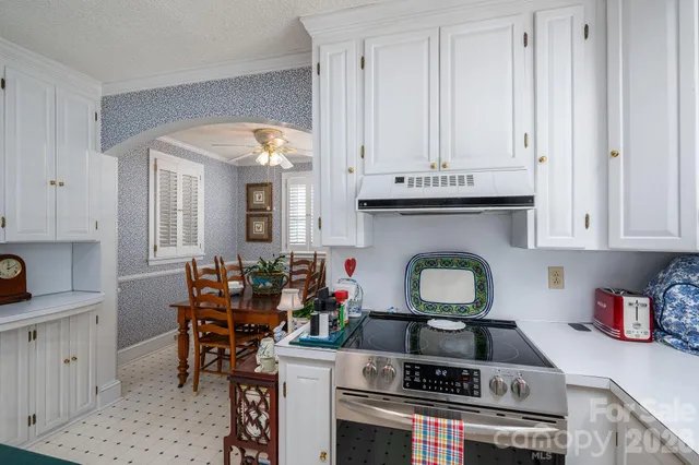 a kitchen with stainless steel appliances granite countertop a stove and cabinets