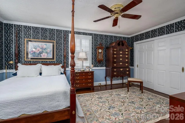 a bedroom with a bed a table and chair