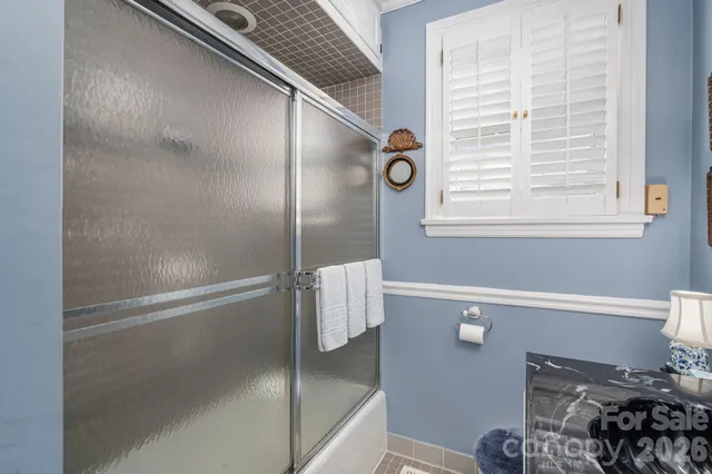 a bathroom with a bathtub and a window