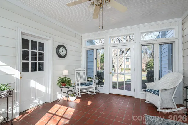 a living room with furniture a front door and a potted plant