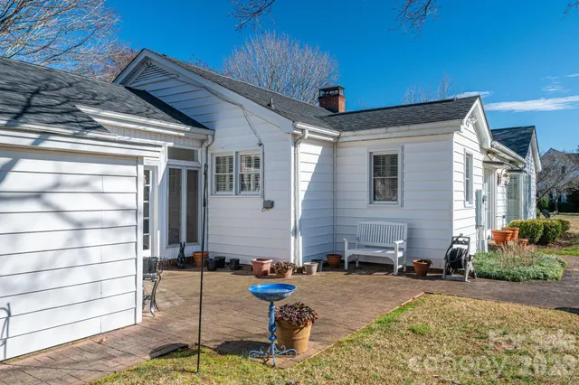 a view of a porch with a table and chairs
