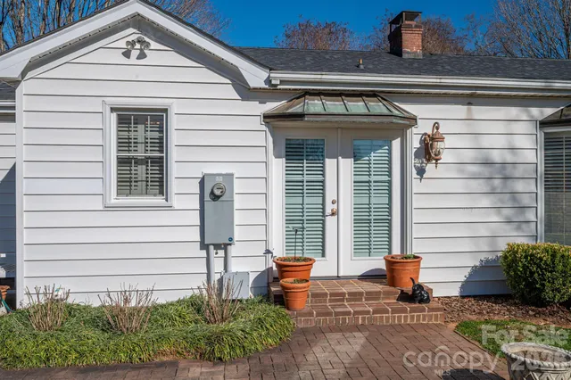 a view of a backyard with a tree