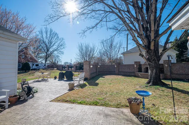 a view of a house with a yard and sitting area