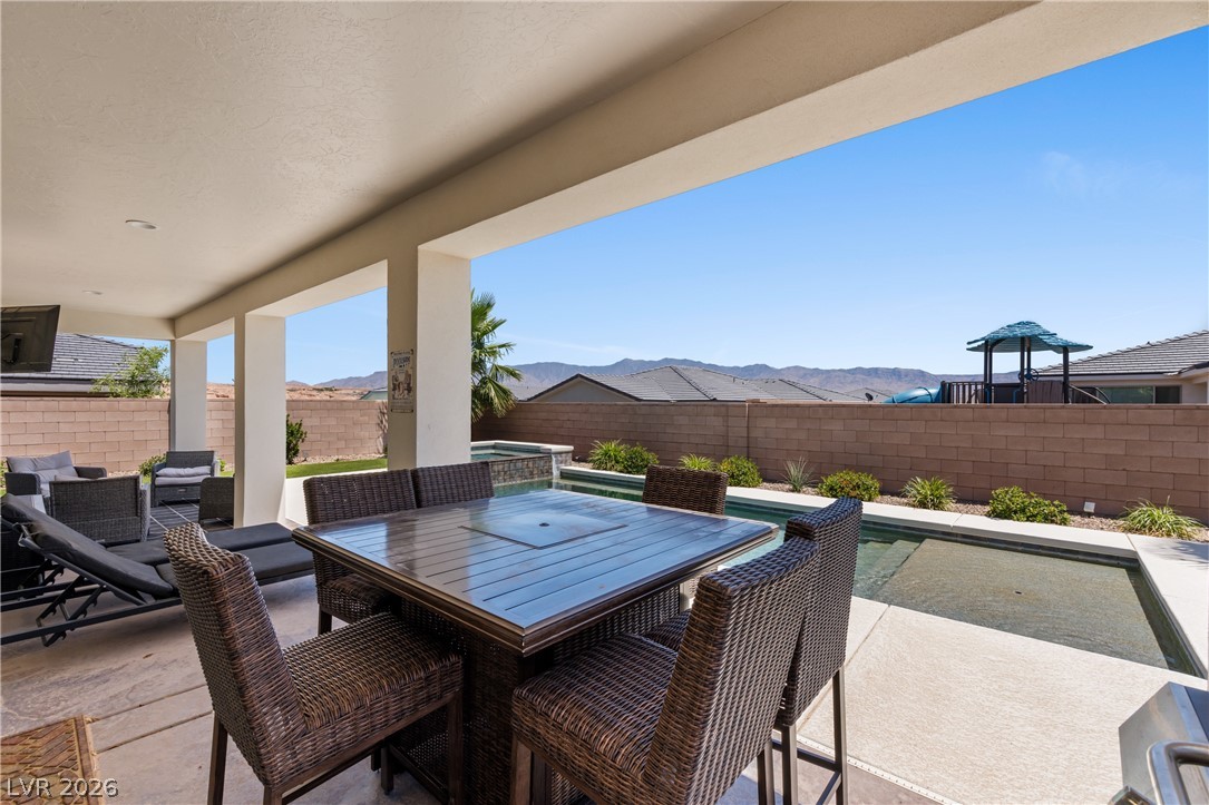 1436 Manassas Ridge Mesquite, NV 89027 - Photo 45 of 77 An inviting covered patio offers seamless indoor-outdoor living with a private pool and panoramic mountain views.