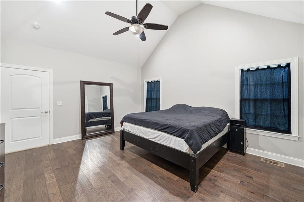 1006 Owens Store Road Canton, GA 30115 - Photo 20 of 48 a spacious bedroom with a bed and a cabinets