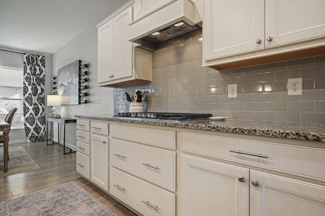 a bathroom with a granite countertop bathtub a mirror and a shower