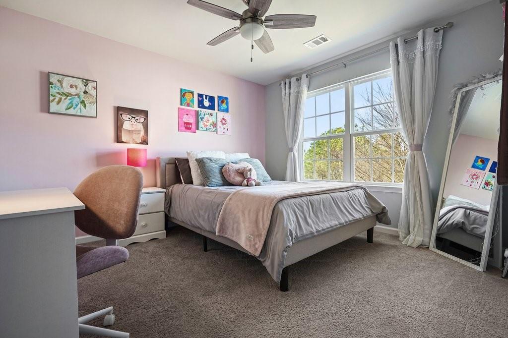 451 Timberleaf Road Canton, GA 30115 - Photo 25 of 38 a bedroom with a bed and a chandelier