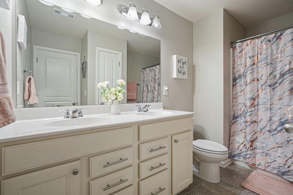 451 Timberleaf Road Canton, GA 30115 - Photo 27 of 38 a bathroom with a double vanity sink mirror and toilet