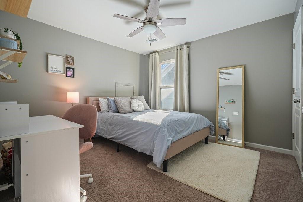 451 Timberleaf Road Canton, GA 30115 - Photo 30 of 38 a bedroom with a bed and a chandelier