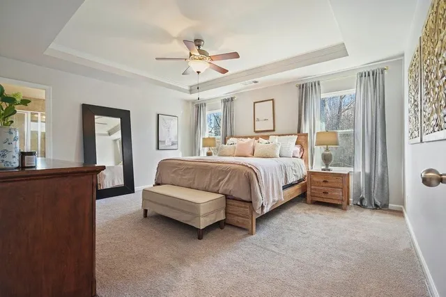 a kitchen with stainless steel appliances granite countertop a stove top oven a sink a refrigerator and white cabinets with wooden floor