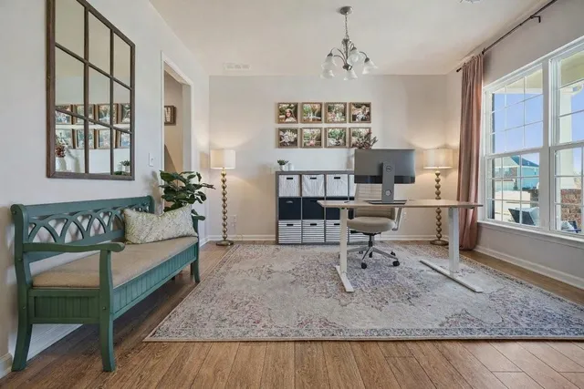 a work room with furniture and wooden floor