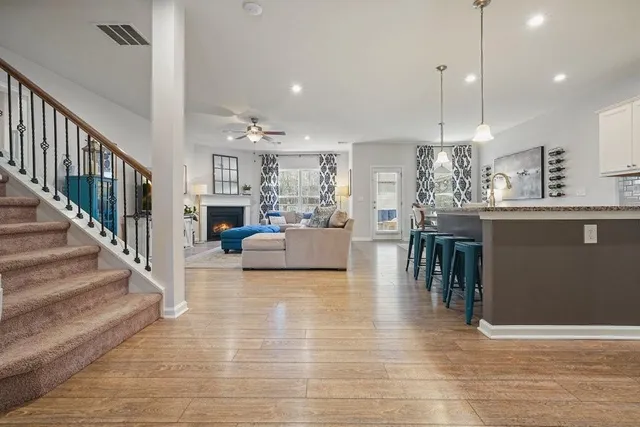 a view of a kitchen with wooden floor and cabinets