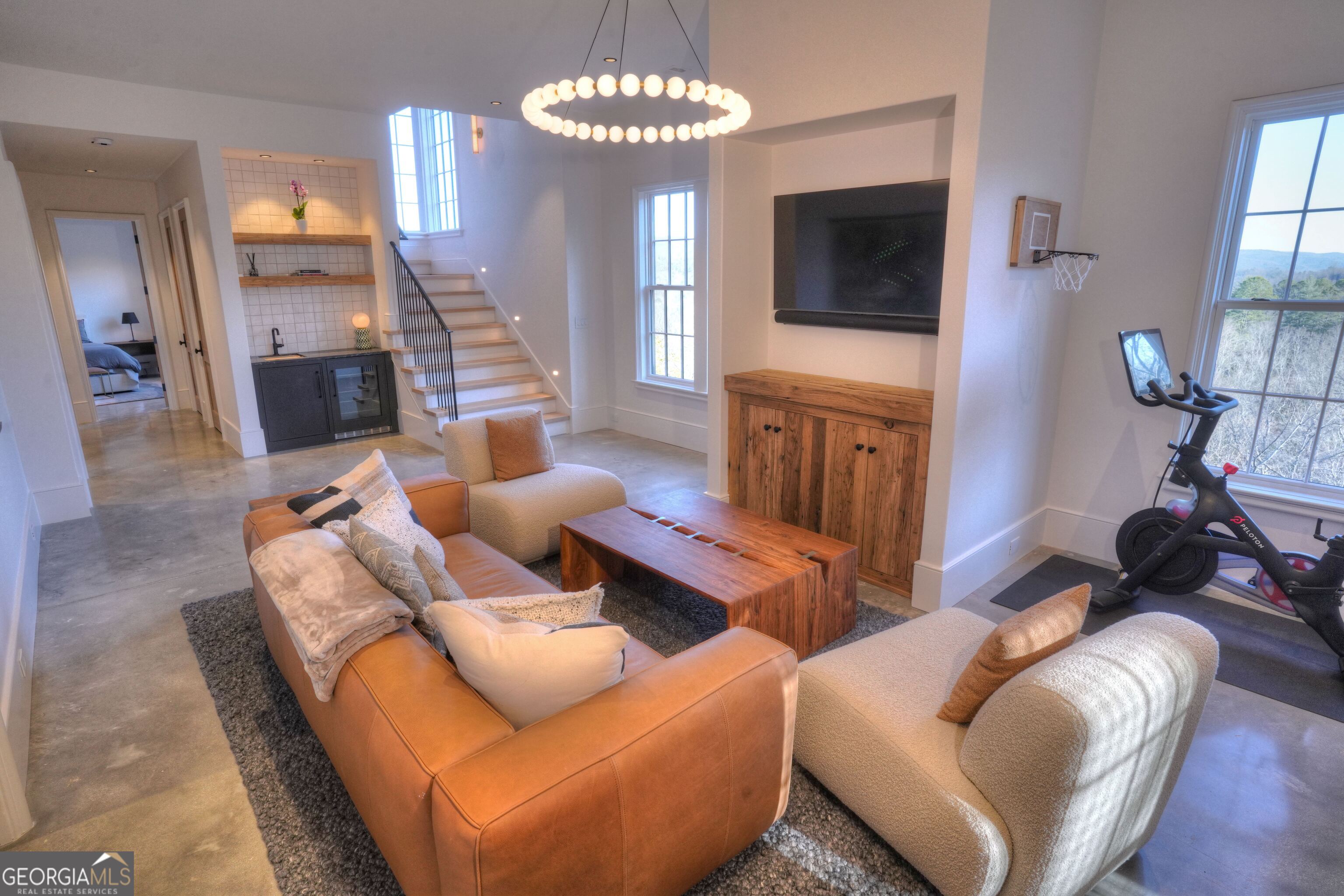 814 Summit Ridge Drive Clarkesville, GA 30523 - Photo 65 of 85 a living room with furniture a flat screen tv and a window