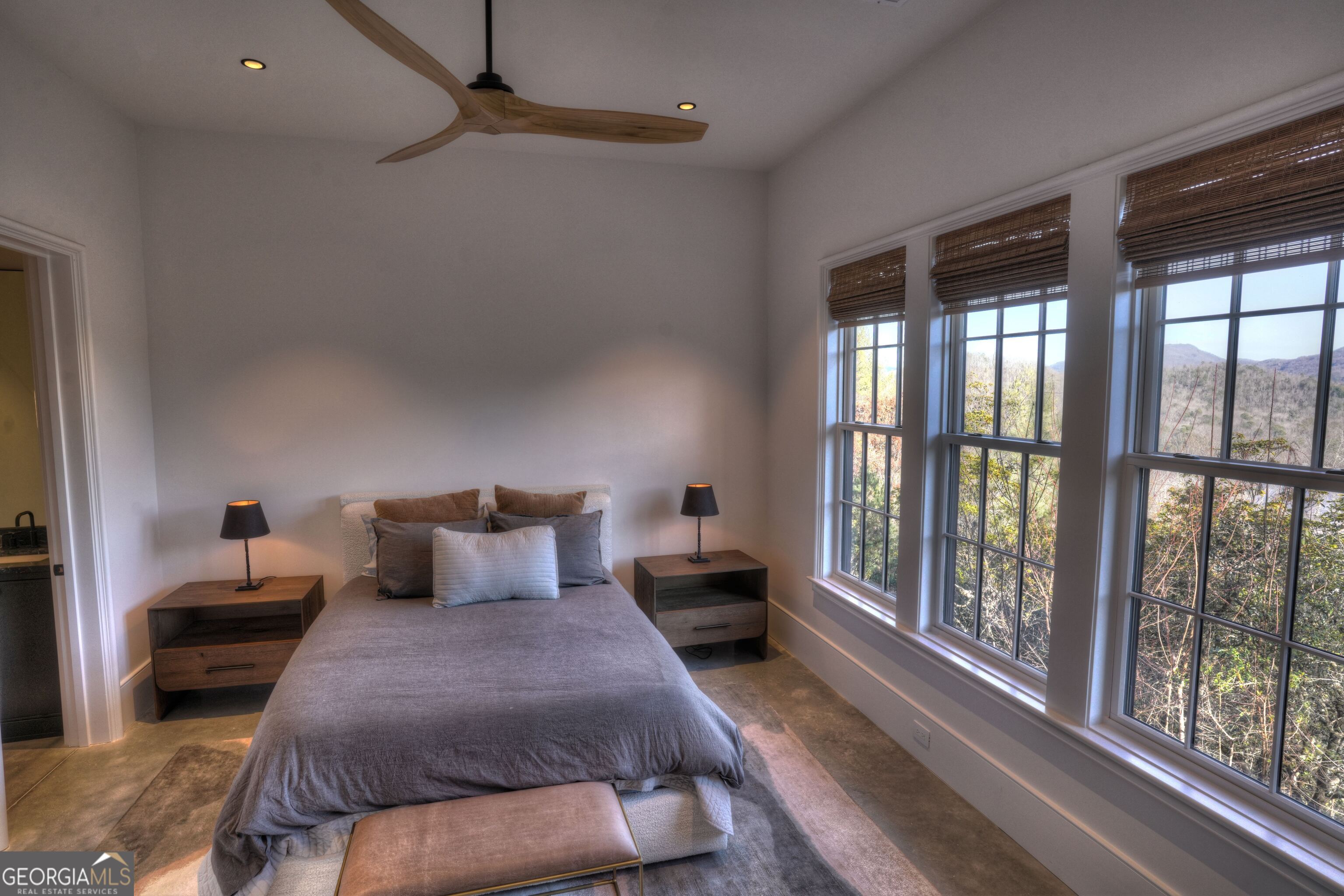 814 Summit Ridge Drive Clarkesville, GA 30523 - Photo 68 of 85 a bedroom with furniture and large windows