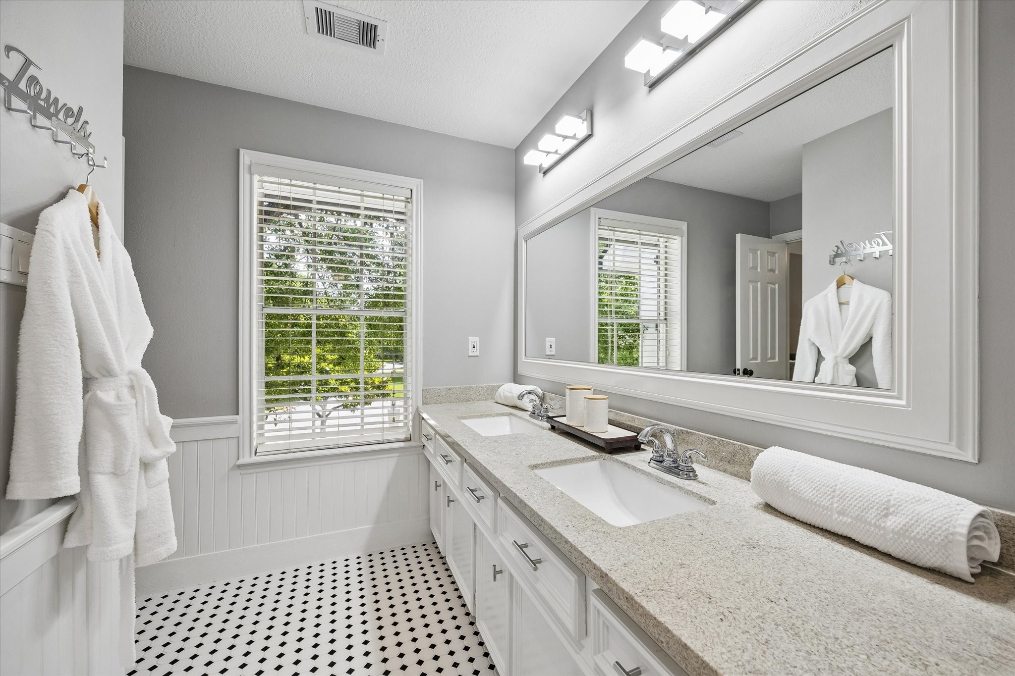 146 Golden Shadow Circle Spring, TX 77381 - Photo 29 of 41 The updated secondary Jack and Jill bathroom features a long dual-sink vanity with generous countertop space. Classic black-and-white mosaic tile flooring adds timeless character and charm, creating a space that is both stylish and functional for family and guests alike.