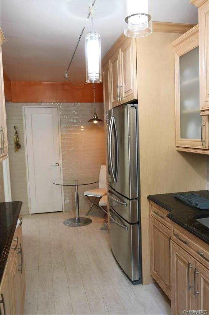 34-10 75th Street, Unit K2 Queens, NY 11372 - Photo 11 of 16 a kitchen with stainless steel appliances granite countertop a refrigerator a sink and a stove