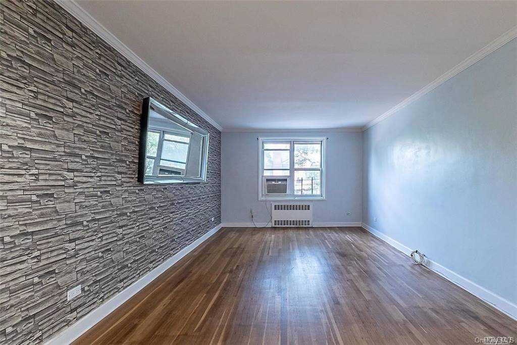 34-10 75th Street, Unit K2 Queens, NY 11372 - Photo 4 of 16 a view of an empty room window and wooden floor