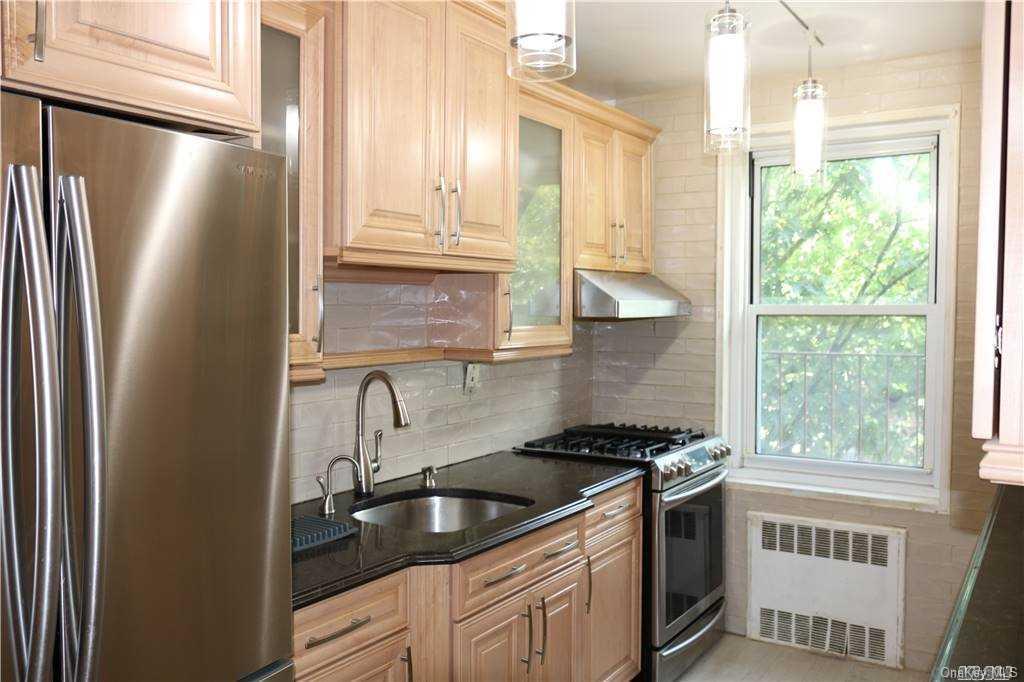 34-10 75th Street, Unit K2 Queens, NY 11372 - Photo 10 of 16 a kitchen with granite countertop a sink stove and refrigerator