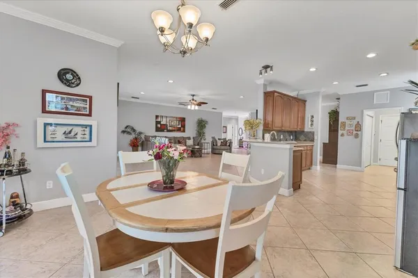 a view of a dining room with furniture and a chandelier