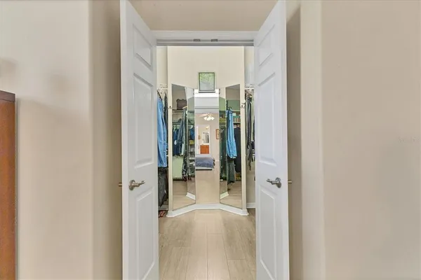 a view of walk in closet with clothes and shoes