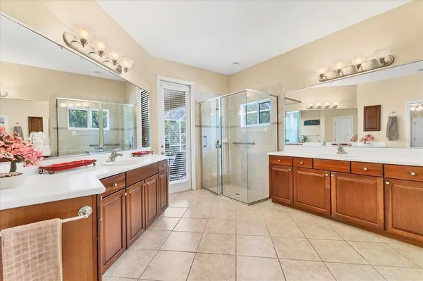 a spacious bathroom with a tub sink and mirror