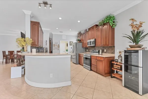 a kitchen with kitchen island granite countertop a stove a sink and a refrigerator