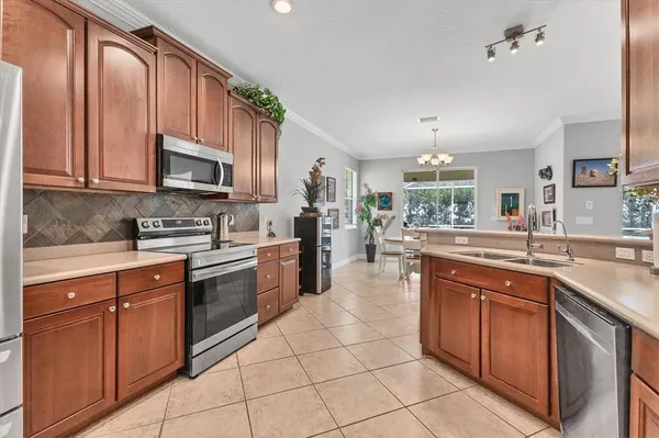 a kitchen with stainless steel appliances granite countertop a sink and cabinets