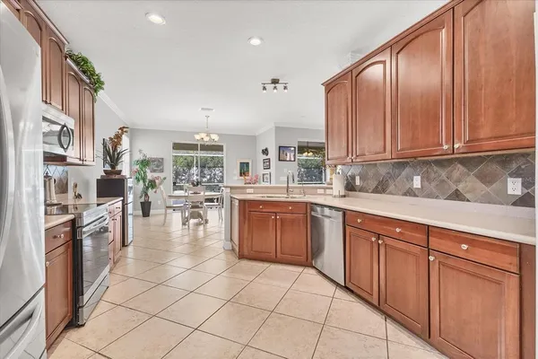 a kitchen with stainless steel appliances granite countertop a stove a sink dishwasher and a refrigerator