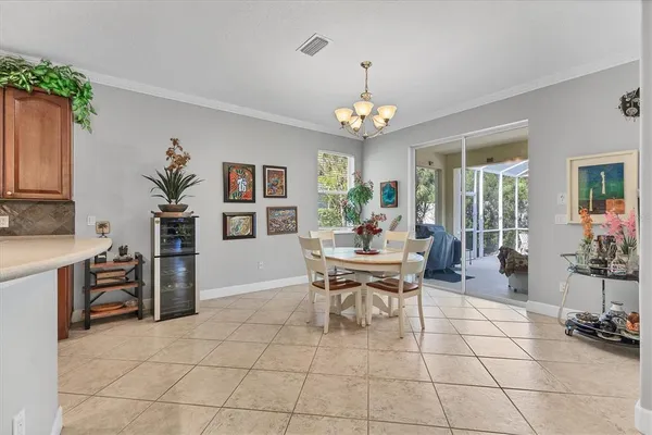 a view of a dining room with furniture and chandelier