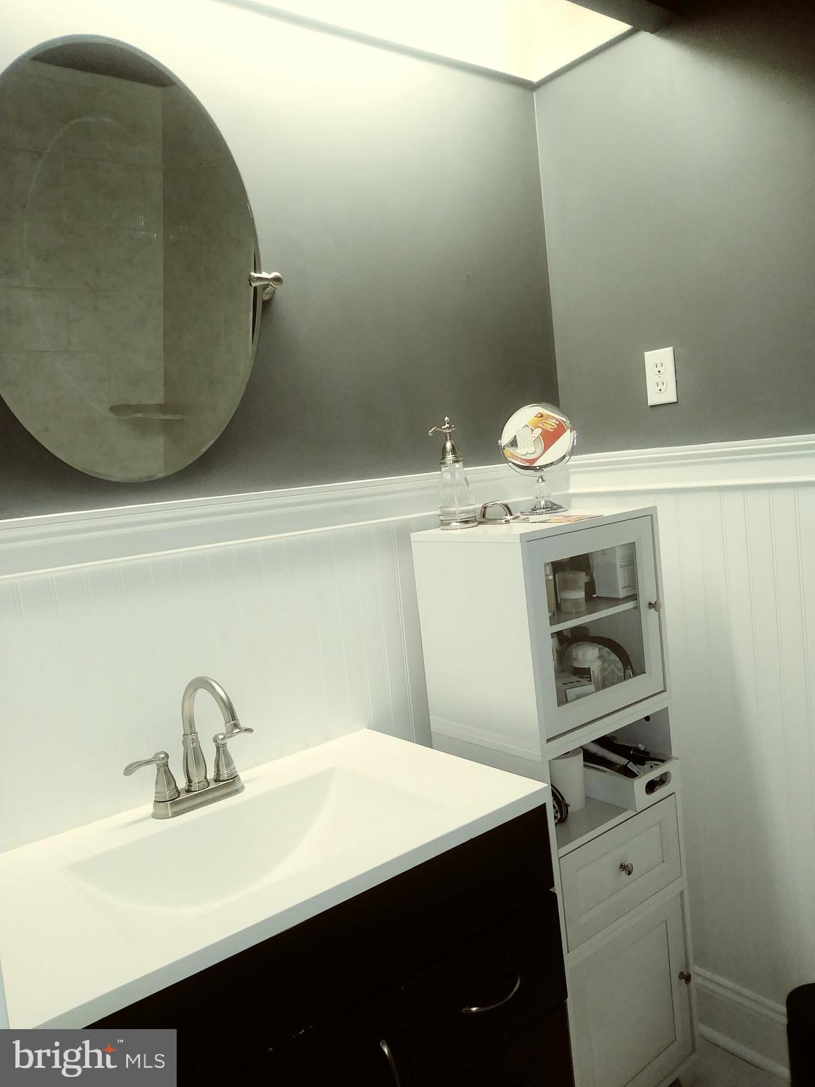 1010 Race Street, Unit 8M Philadelphia, PA 19107 - Photo 11 of 13 a bathroom with a sink and a mirror