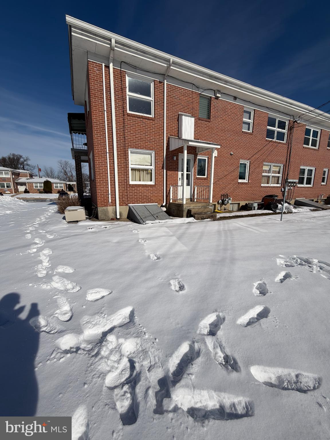 118 Gretchen Drive Reading, PA 19607 - Photo 33 of 33 Footprints in fresh snow by a brick building.