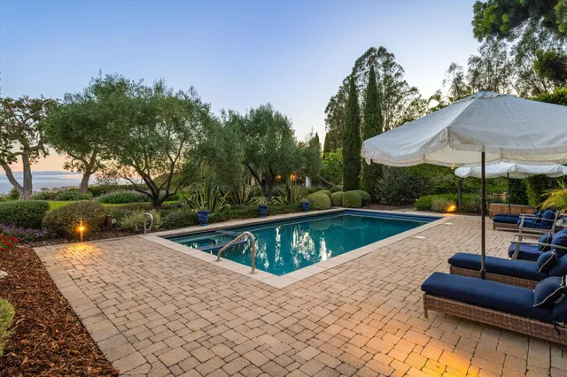 a view of swimming pool with chairs in patio