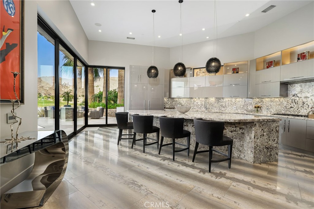 49967 Ridge View Way Palm Desert, CA 92260 - Photo 20 of 68 a view of dining room kitchen with stainless steel appliances kitchen island granite countertop a table chairs and a sink