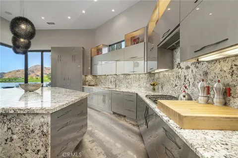 a view of a chairs and table in the balcony